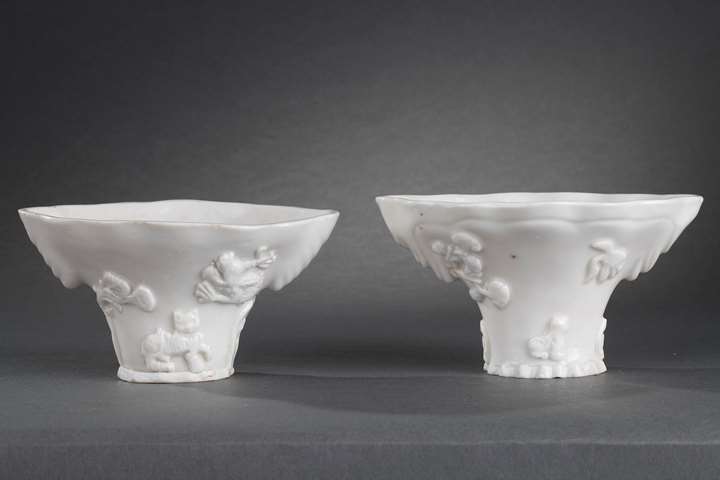 Pair of "blanc de Chine" rhinoceros horn shaped cups with animals decoration like: tiger dragon deer or crane